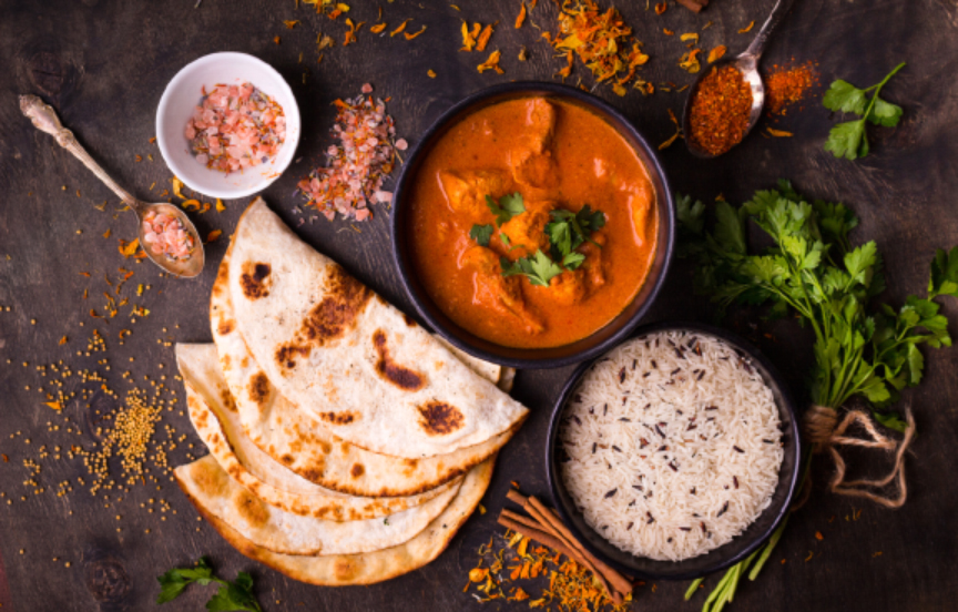 chicken tikka masala dinner on black background